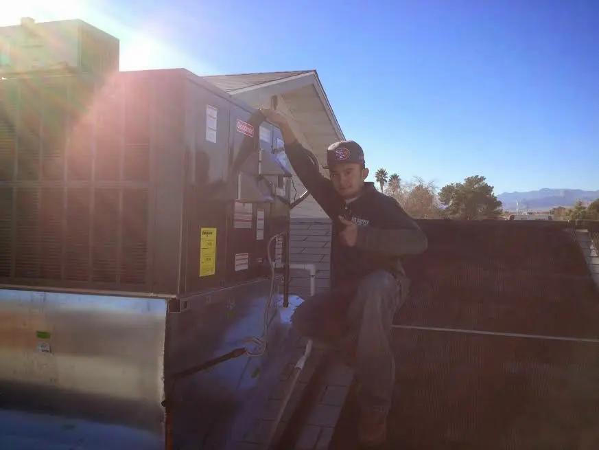 HVAC technician performing HVAC Inspection on a rooftop unit in Marshall